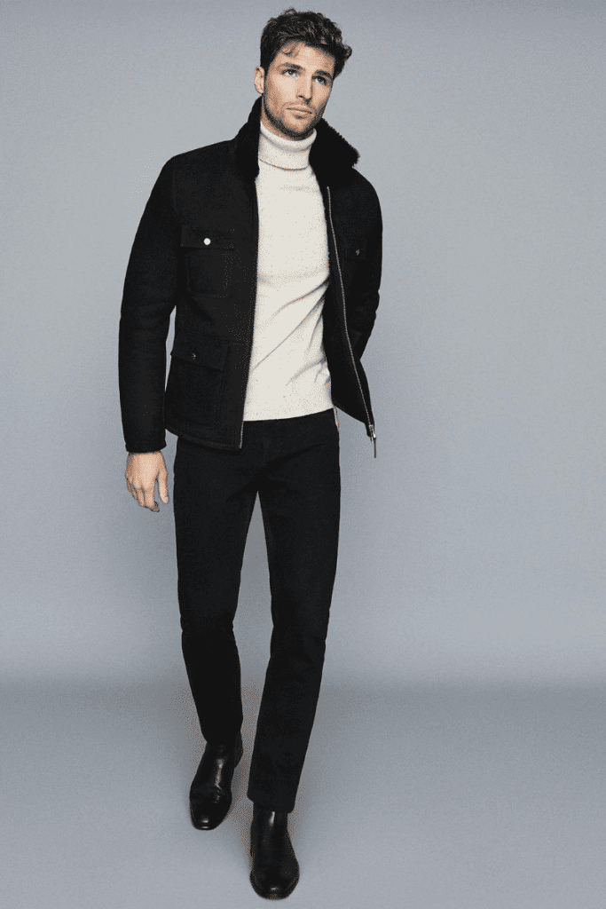 model wearing roll neck and chelsea boots